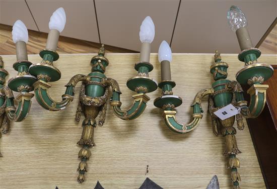 A set of three green and gilt painted twin branch wall lights, in late 18th century style